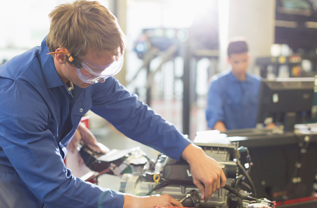 Mechanic working on engine in auto repair shop-pre-apprenticeship